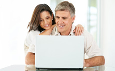 Photo of a couple looking at a laptop computer screen